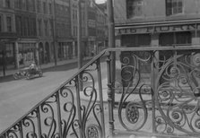 Street seen from behind the wrought iron railing of the Market Hall, Charleston..., c1920-c1926. Creator: Arnold Genthe.