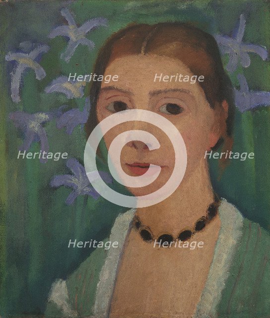 Self portrait in front of green background with blue irises, c. 1905.