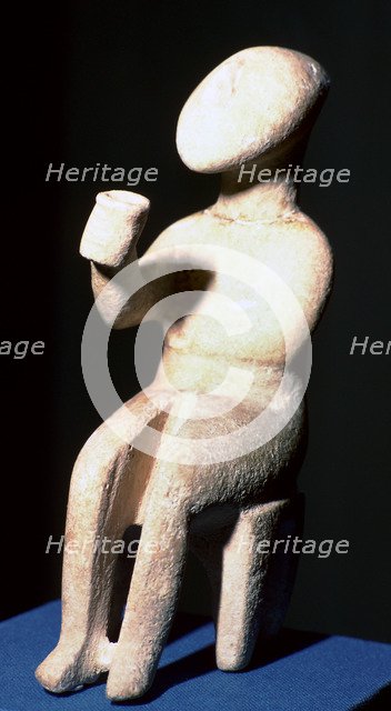 Cycladic marble seated figure holding a cup. Artist: Unknown