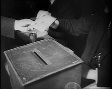 Men Sitting Around a Ballot Box, 1933. Creator: British Pathe Ltd.