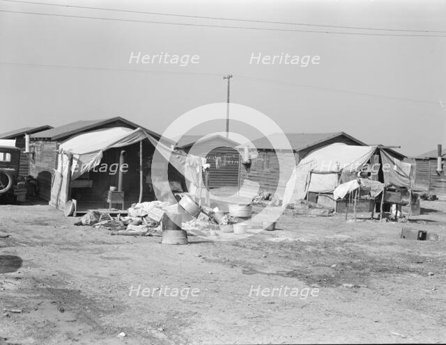 Company housing for cotton workers near Corcoran, California, 1936. Creator: Dorothea Lange.