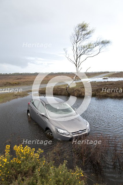 Ford Focus in flooded ditch after losing control on wet road 2012 Artist: Unknown.