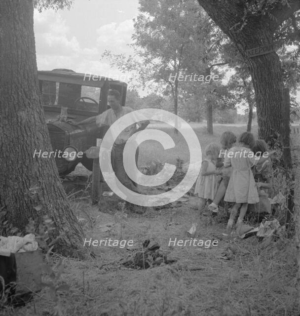 Migrant family from Oklahoma in Texas, alongside the road, 1936. Creator: Dorothea Lange.