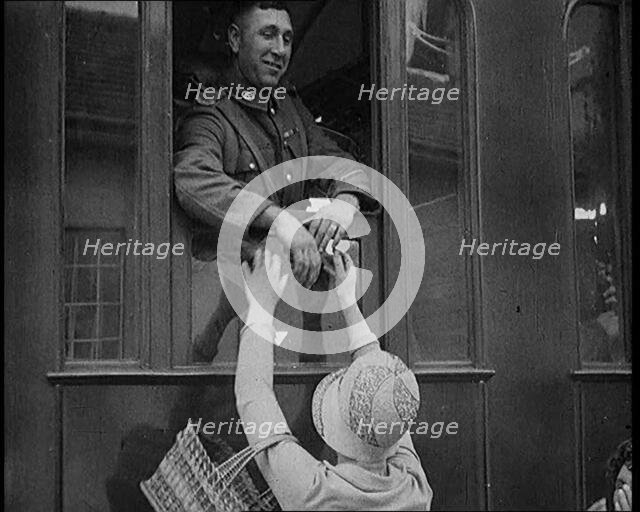 Male Soldier Kissing Female Civilian from the Window of a Train, 1929. Creator: British Pathe Ltd.