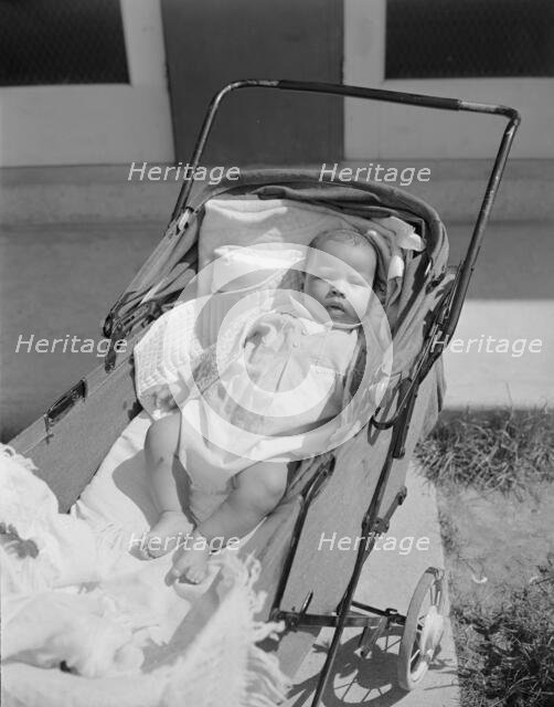 Baby taking a sun bath, Frederick Douglass housing project, Anacostia, D.C., 1942. Creator: Gordon Parks.