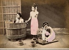 Three Japanese women washing: One in a wooden tub, one standing and one crouching..., c1890s. Creator: Unknown.