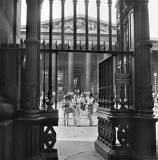 Three young women walk towards the exit gateway of the British Museum, Camden, London, c1946-c1959. Artist: John Gay