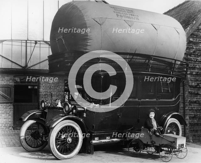 1913 Lanchester with gas bag conversion and boy in pedal car. Creator: Unknown.