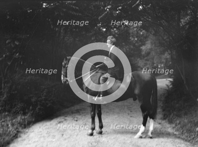 Arnold Genthe riding Chesty, between 1911 and 1936. Creator: Arnold Genthe.