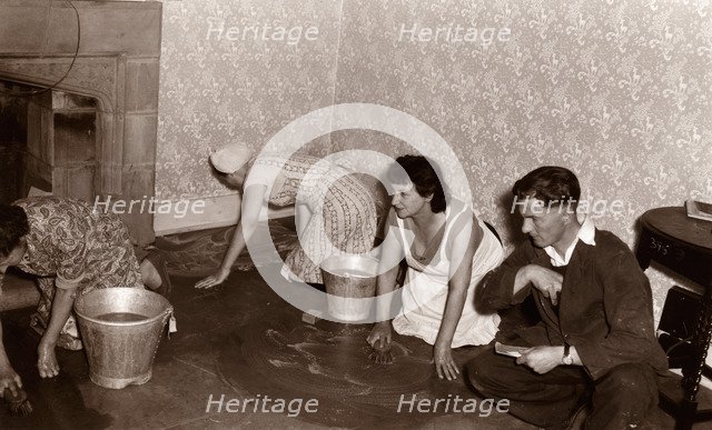 Three women scrub a stone floor on their hands and knees, 1956. Artist: Unknown
