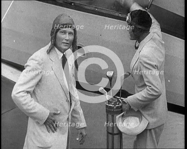 Two Golfers With Gold Clubs Enter a Gyrocopter, 1932. Creator: British Pathe Ltd.