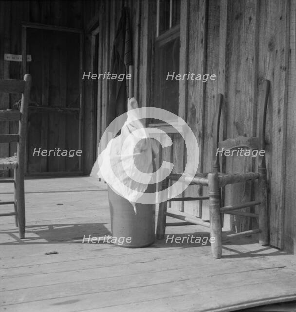 Pottery butter churn on porch of Negro tenant family, Randolph County, North Carolina, 1939. Creator: Dorothea Lange.