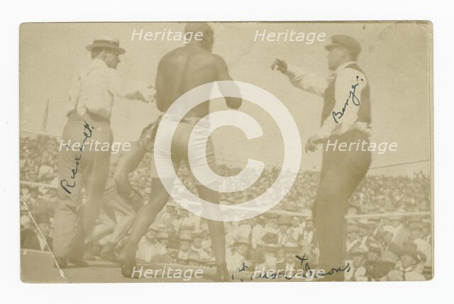 Photographic postcard of James J. Jeffries staggering away from Jack Johnson, 1910. Creator: Unknown.