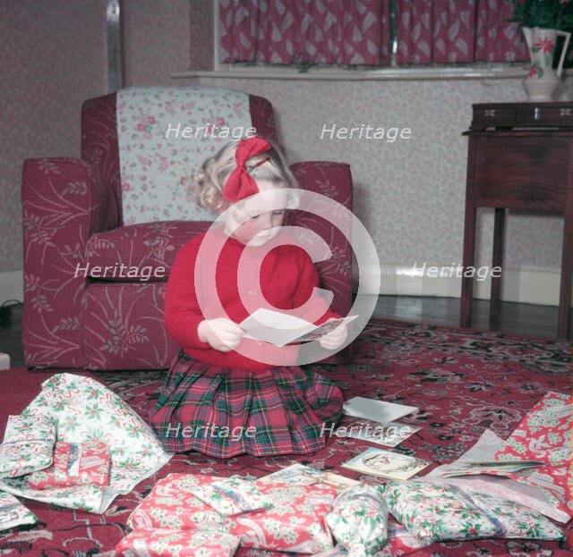 Girl opening her Christmas cards and presents, c1955.  Creator: Arthur Charles Kirby Ware.