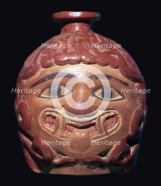 Greek terracotta scent bottle in the shape of a gorgon's head made in Rhodes. Artist: Unknown