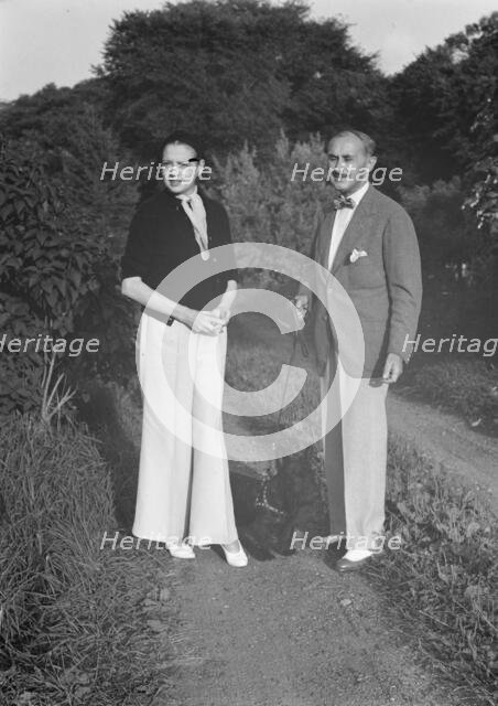Leonard, Mr. and Mrs., standing outdoors, between 1926 and 1938. Creator: Arnold Genthe.