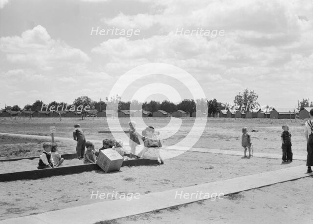 Nursery school children with their teacher, FSA camp, Tulare County, California, 1939. Creator: Dorothea Lange.