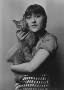 Dolly sister, with Buzzer the cat, portrait photograph, 1916. Creator: Arnold Genthe.