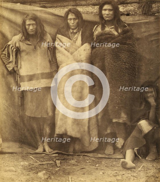 Group of Native Americans, three standing, one seated on the ground, possibly..., 1860 or 1861. Creator: Unknown.