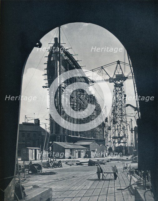 'A striking bow view of the giant Cunard liner, Queen Mary, at Clydebank, Glasgow', 1934. Artist: Unknown.