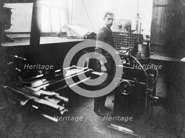 Man in a printing workshop, (late 19th-early 20th century?). Artist: W Martin