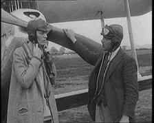 American Aviator Amelia Mary Earhart Wearing a Helmet in Front of an Airplane, 1920. Creator: British Pathe Ltd.