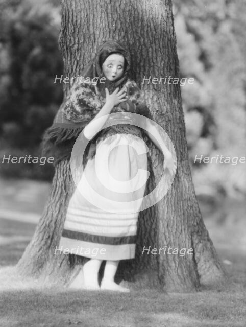 Person wearing a mask made by W.T. Benda, 1925 Sept. 20. Creator: Arnold Genthe.