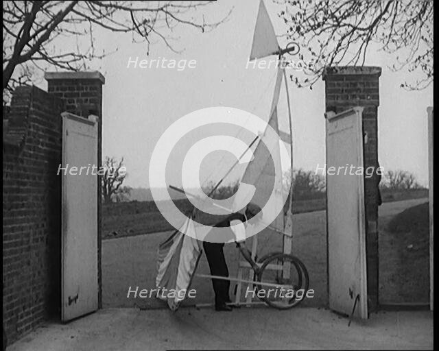 Male Civilian Carrying a Small Pedal Powered Flying Machine and Trying to Demonstrate It in a..., 19 Creator: British Pathe Ltd.