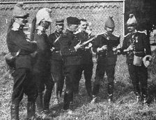 'L'aide Francaise a la Belgique; A l'ecart, l'etat-major de la brigade etudie la carte', 1914. Creator: Unknown.