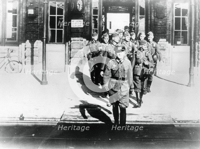 German army officer leading his company onto a railway station platform, Paris, August 1940. Artist: Unknown