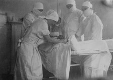 Cutting off a foot -- Canadian Hospital, Le Touquet, between 1914 and c1915. Creator: Bain News Service.