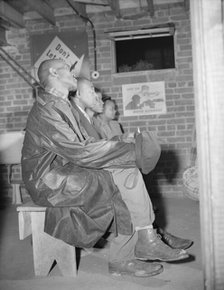 Air raid wardens attending a meeting in their headquarters, Washington, D.C., 1943. Creator: Gordon Parks.