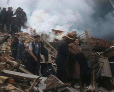 Firefighters Helping an Injured Civilian During the Blitz, 1940. Creator: British Pathe Ltd.