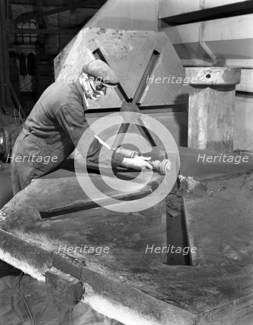 Grinding the flashing from a casting, AT Green & Sons Ltd, Rotherham, South Yorkshire, 1963. Artist: Michael Walters