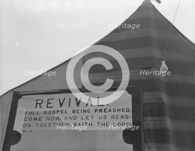 Revival meetings are held in Yakima shacktown, Sumac Park, Yakima, Washington , 1939. Creator: Dorothea Lange.
