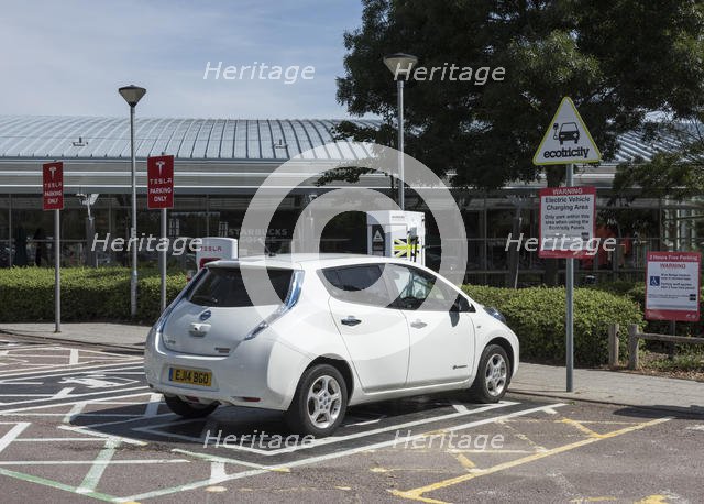 Nissan Leaf at elctric charging point 2015. Creator: Unknown.