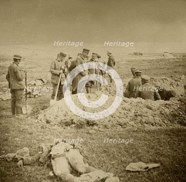 Burying bodies, Sainte-Marie-à-Py, northern France, c1914-c1918.  Artist: Unknown.