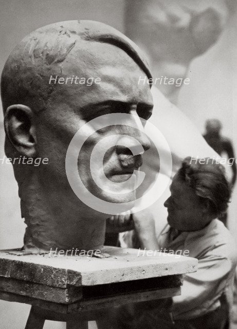 A sculptor working on a large portrait bust of Adolf Hitler, Germany, 1936. Artist: Unknown