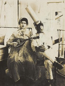 Two sailors (?) on board ship: one in drag is playing a guitar, 1907. Creator: Unknown.