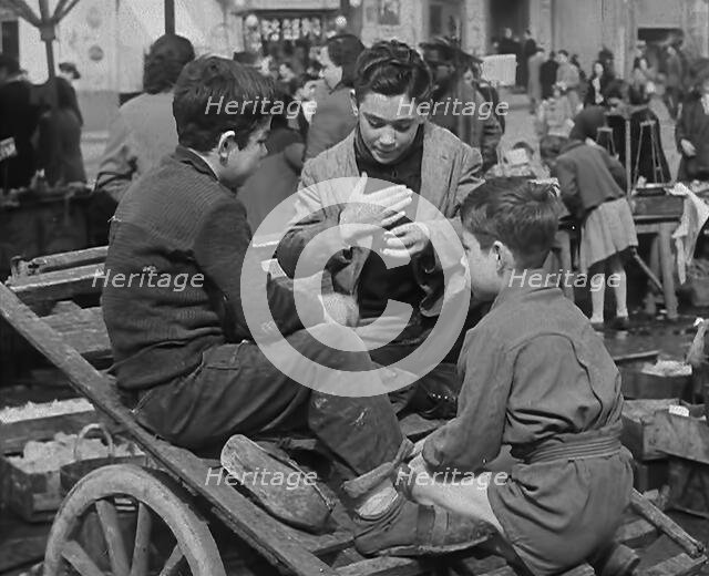 Italian Boys Talking With Other Civilians in the Background, 1944. Creator: British Pathe Ltd.