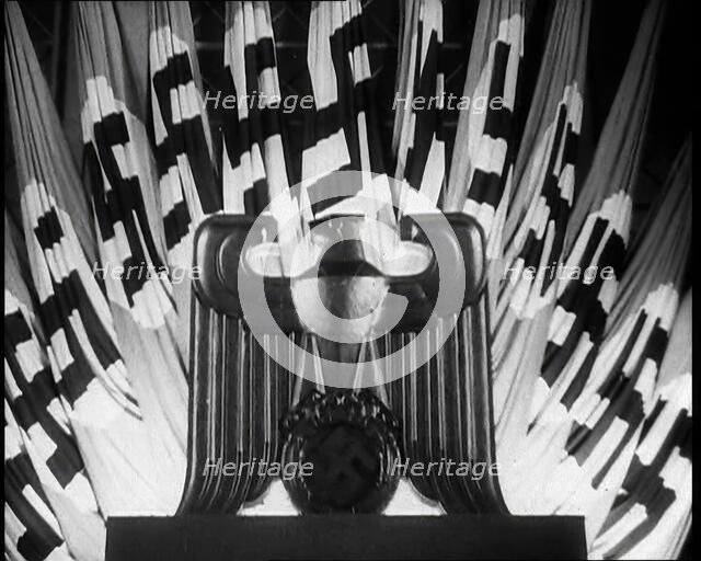 German Eagle Statue With German Flags Behind Bearing the Nazi Swastika, 1937. Creator: British Pathe Ltd.