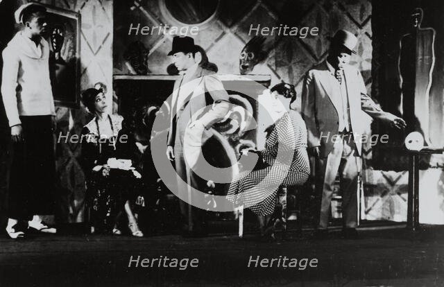 Three men standing, two women sitting, 1935 - 1939. Creator: Milton Meltzer.
