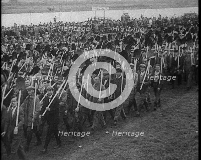 Parade of German Men with Spades and Shovels, 1933. Creator: British Pathe Ltd.