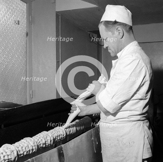 Making a Baumkuchen ('tree cake'), Landskrona, Sweden, 1952. Artist: Unknown