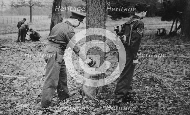 Demonstration of how to place limpet mines, c1943. Creator: British Government.