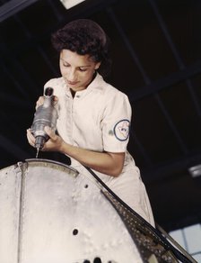 Oyida Peaks riveting as part of her NYA training...Naval Air Base, Corpus Christi, Texas, 1942. Creator: Howard Hollem.