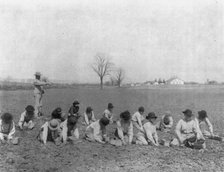 Carlisle Indian School, Carlisle, Pa. Boys digging for potatoes(?) in field, 1901. Creator: Frances Benjamin Johnston.