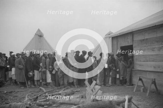 Possibly: Negroes in the lineup for food at meal time in the camp..., Forrest City, Arkansas, 1937. Creator: Walker Evans.