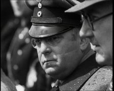 Three Men in a Crowd Listening to a Speech, 1930s. Creator: British Pathe Ltd.