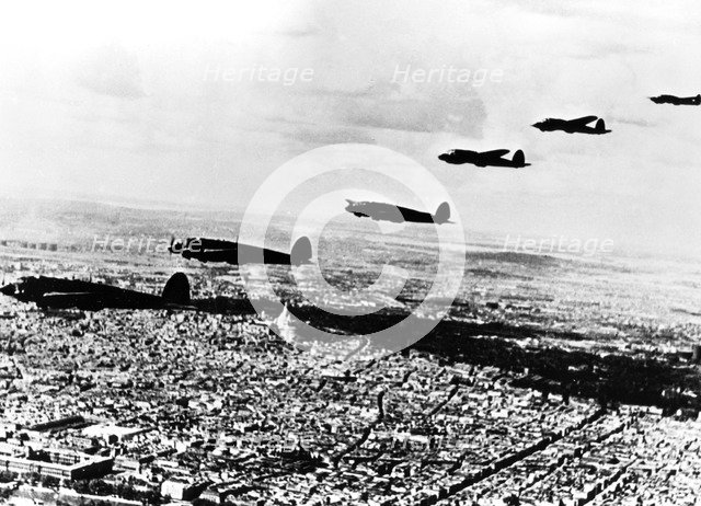 Squadron of German Heinkel He 111 bombers flying over occupied Paris, July 1940. Artist: Unknown